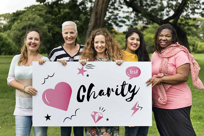 nonprofits and charities team members holding a banner with hearts