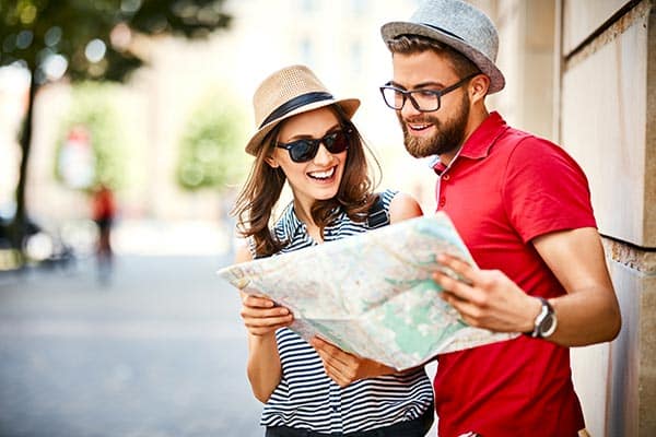couple planning trip with a map marketing organization destination