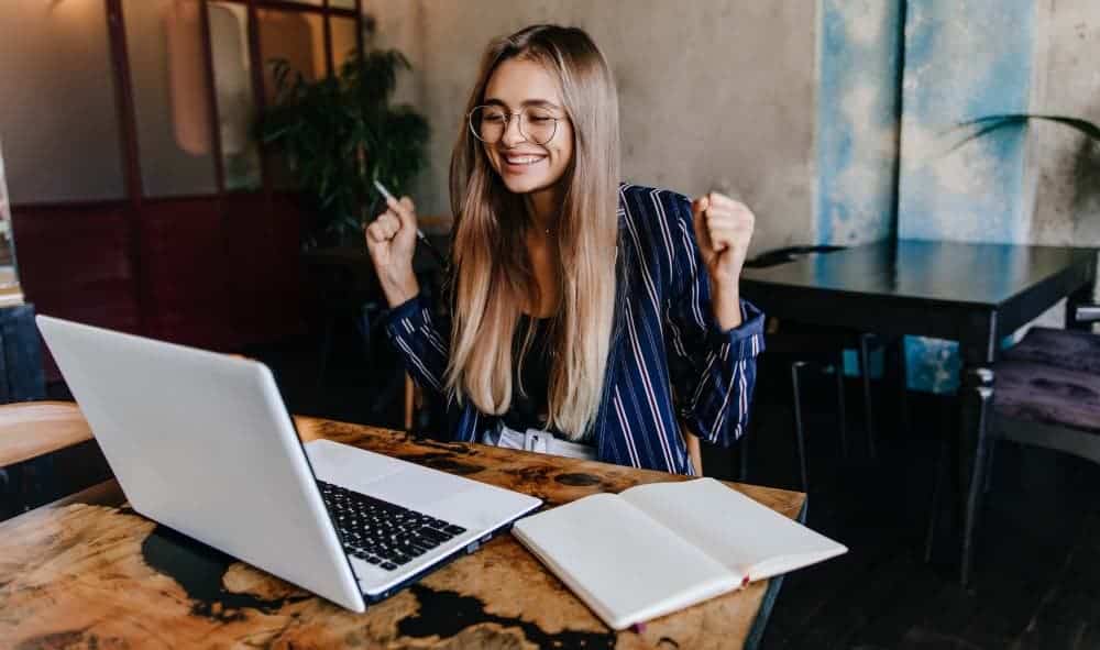 female event planner smiling for running a successful event with a good event planning process