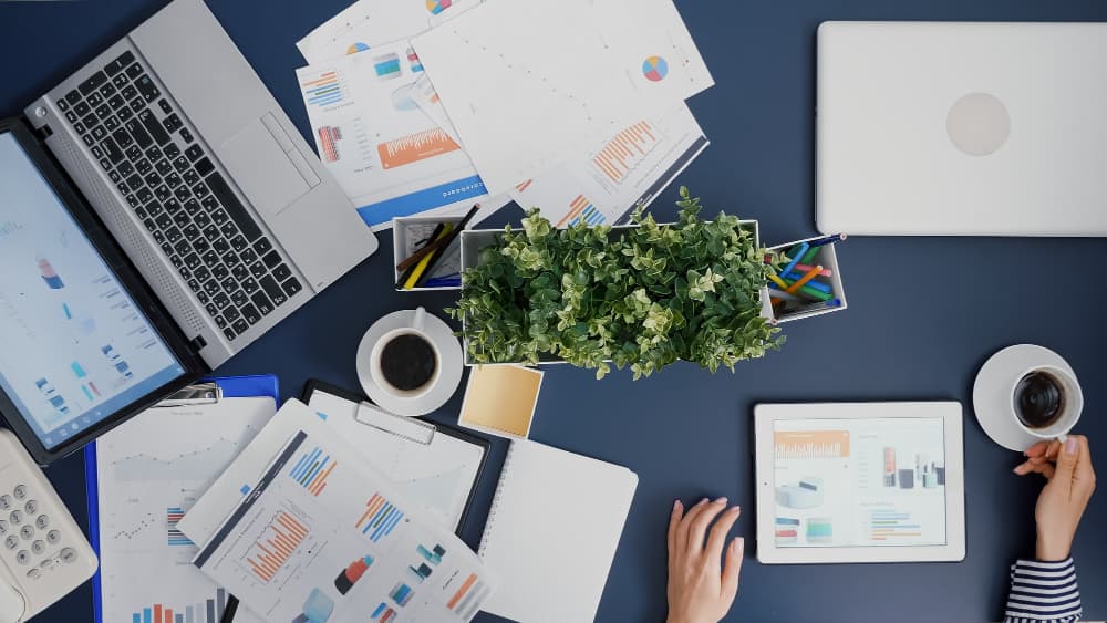 event planner developing marketing campaign on a table as part of her event planning process