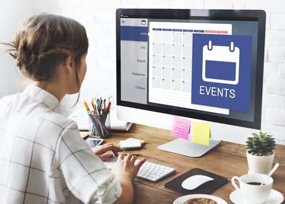 Woman on her computer using Timely event management software to help promote events.
