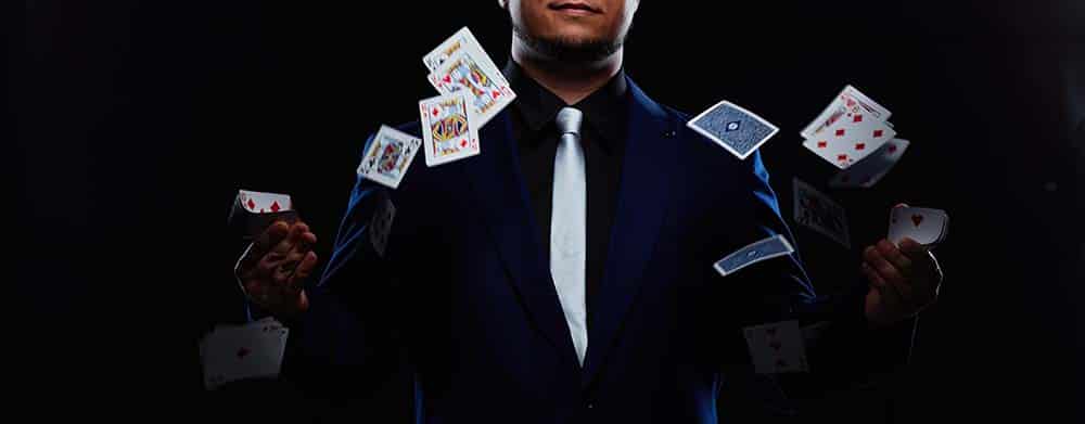 magician throwing cards in the air as an example of entertainment at corporate events