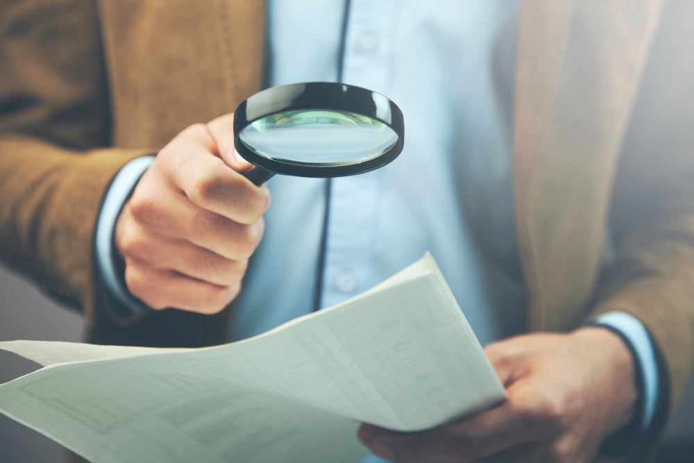 event planner with a magnifying glass on his hand wondering how to get sponsors for events