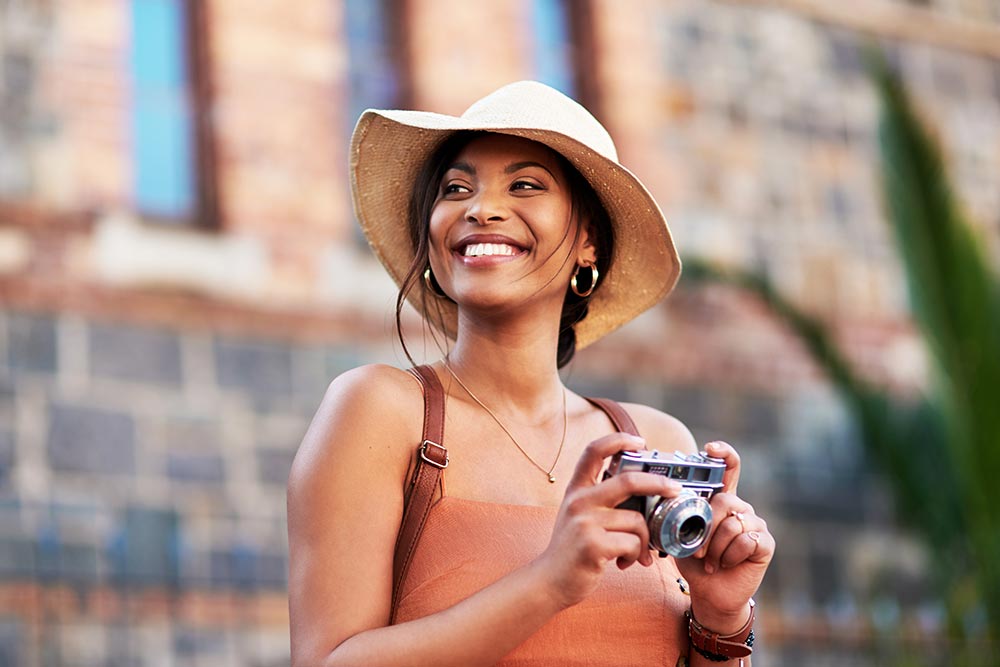 woman visiting a new place with a camera on her hands