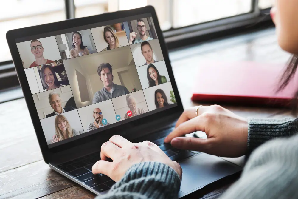 woman logged inn on Zoom with her team for a training on the whiteboard app.