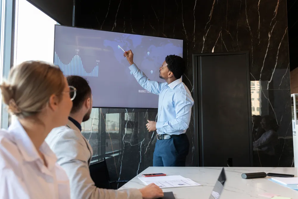 a training provider utilizing an interactive whiteboard to foster engagement with the audience.