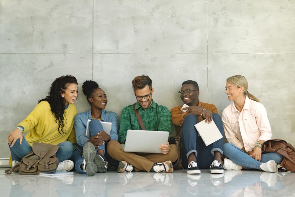 a group of students seated at a hall having a spirited conversation.