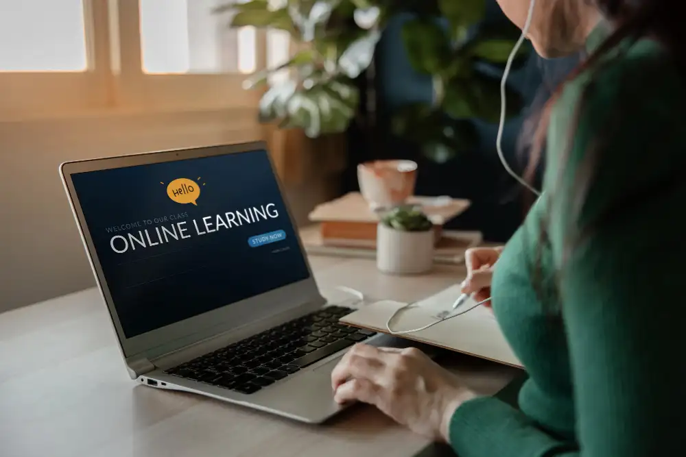 a woman logging into an online learning session on her laptop.