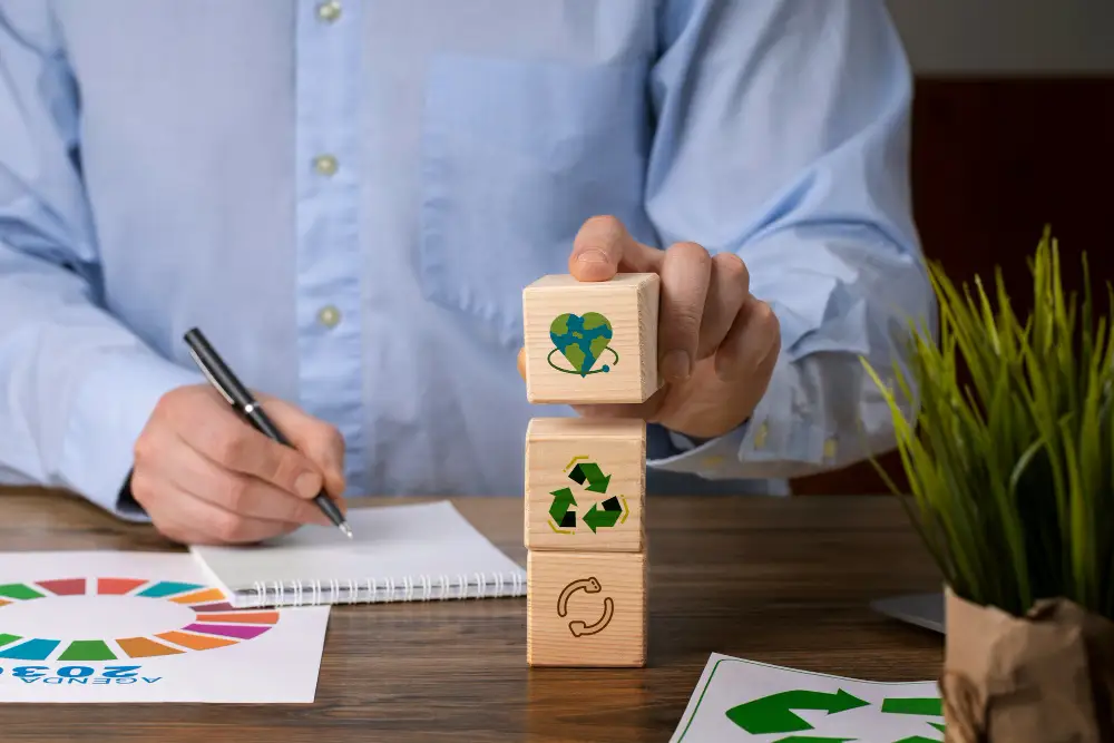 professional man working on a desk by wooden blocks representing sustainable practices.