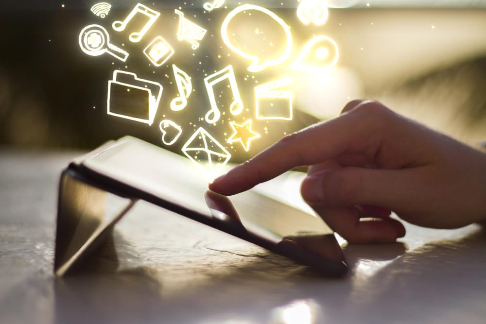 close-up of a hand browsing through a tablet for events calendar software