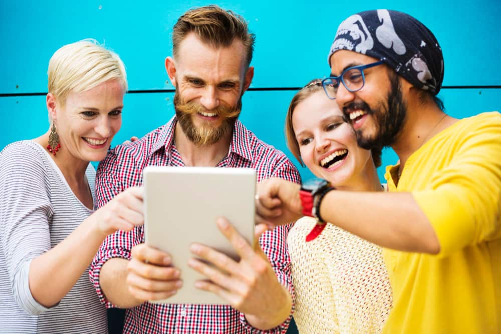 group of people looking at a tablet selecting ideas for event engagement