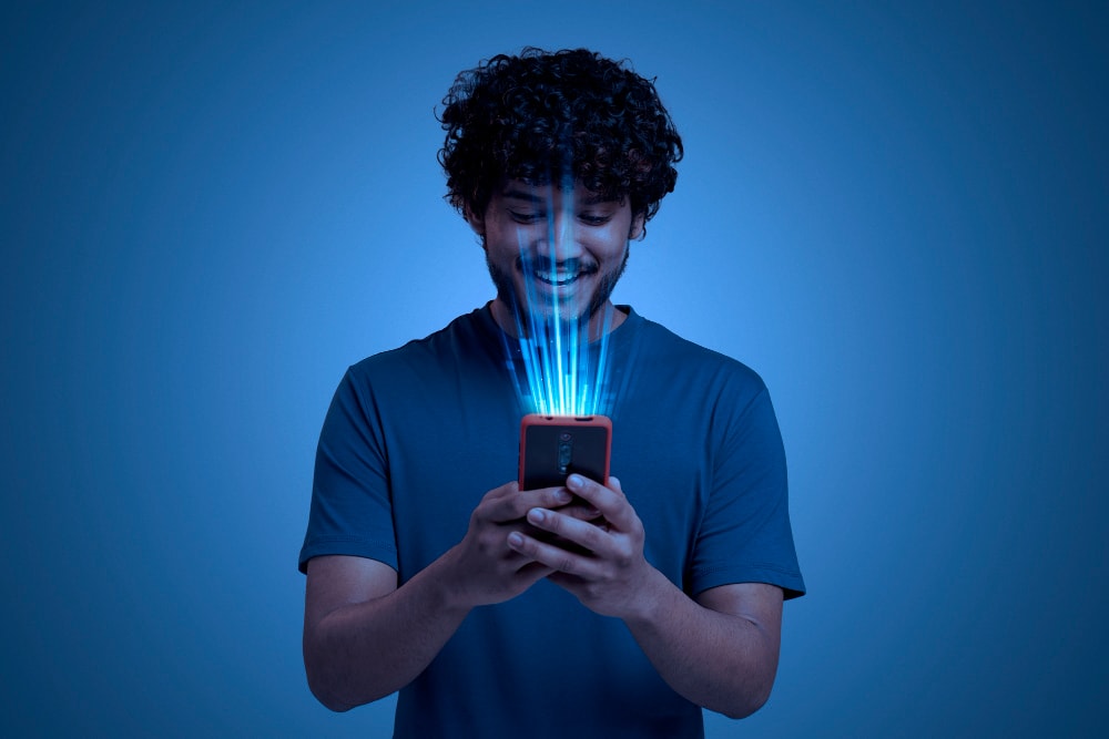 young male using face ID on smartphone.
