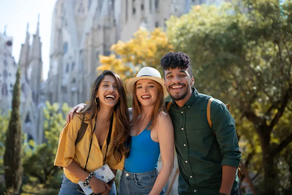 Three friends taking a picture in front of a church during a trip in Europe. 