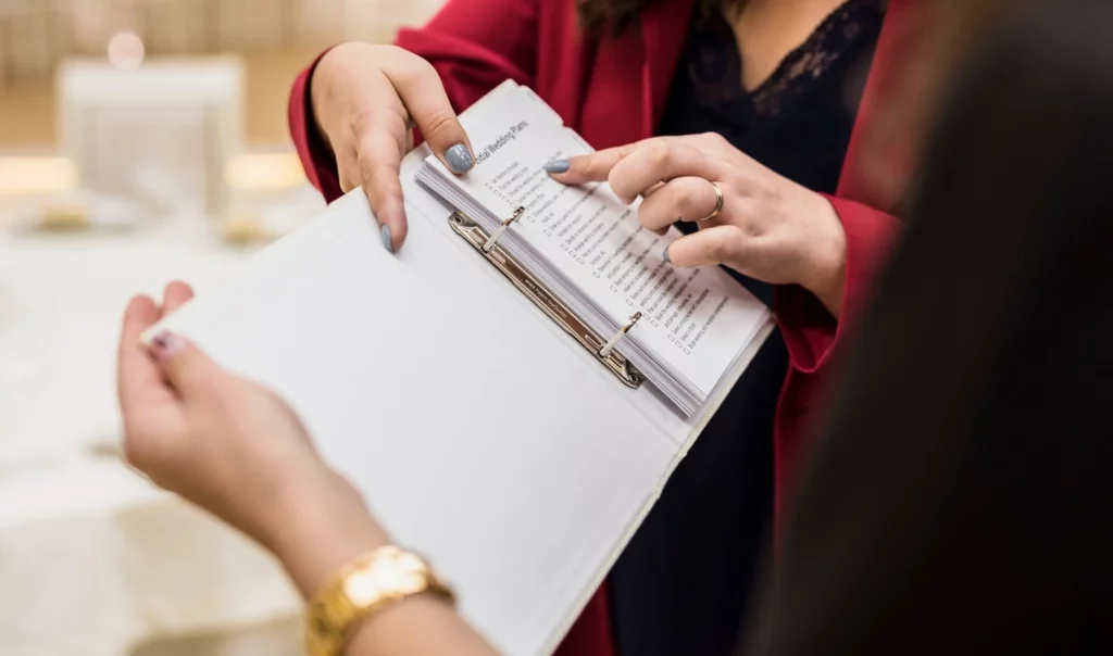 An event organizer detailing event planner rates to a client.