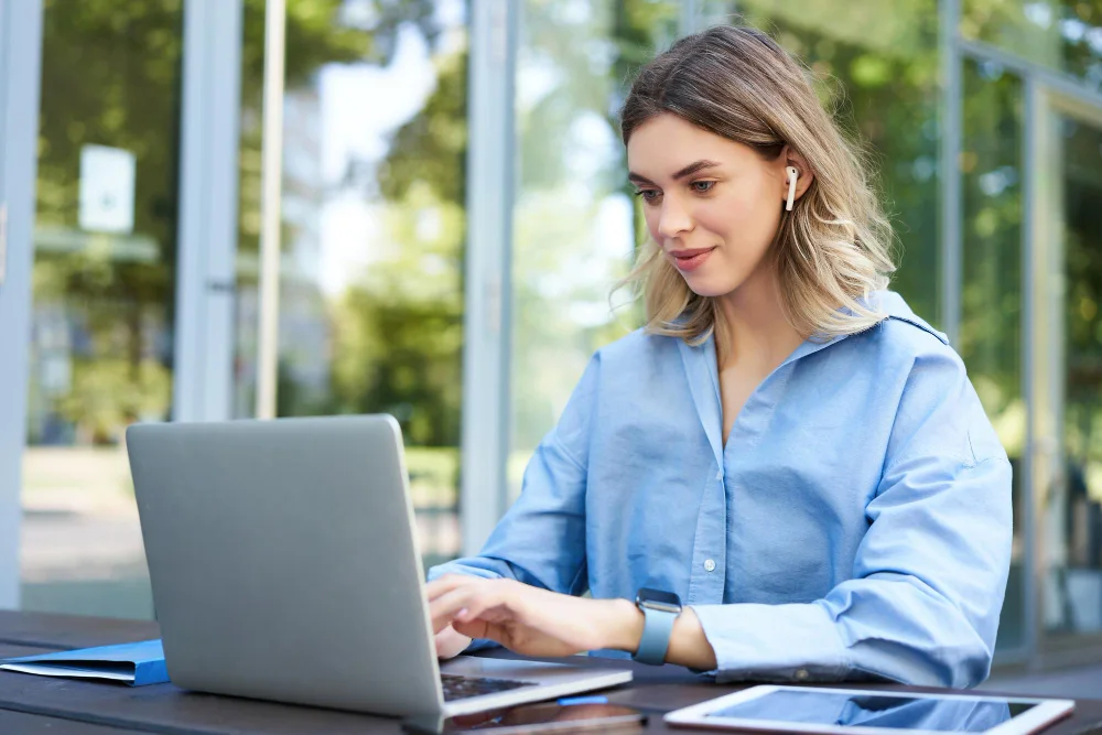 Young female professional using Timely Membership Management Software.