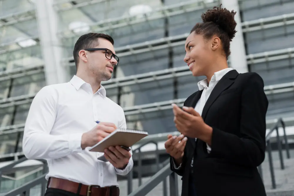 A man and a woman talking about membership management strategies.
